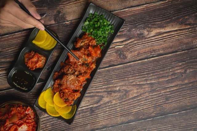Spicy Korean pork with vegetable side dishes