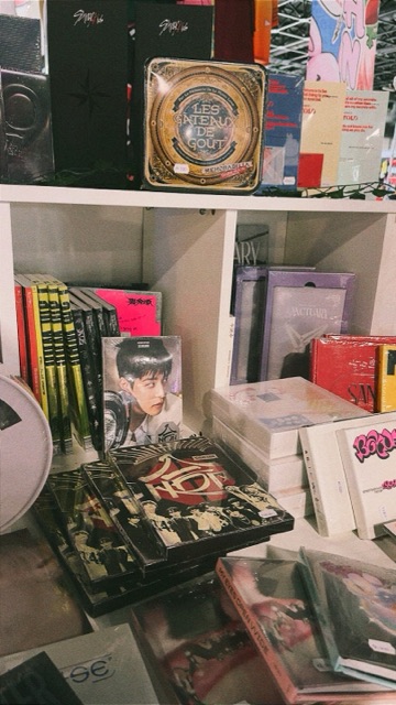K-pop albums and fan publications on shelves