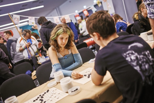 Participants playing a traditional board game